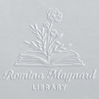 Embossed design of an open book with flowers on a light gray background, featuring the text 'Romina Maynard Library'.