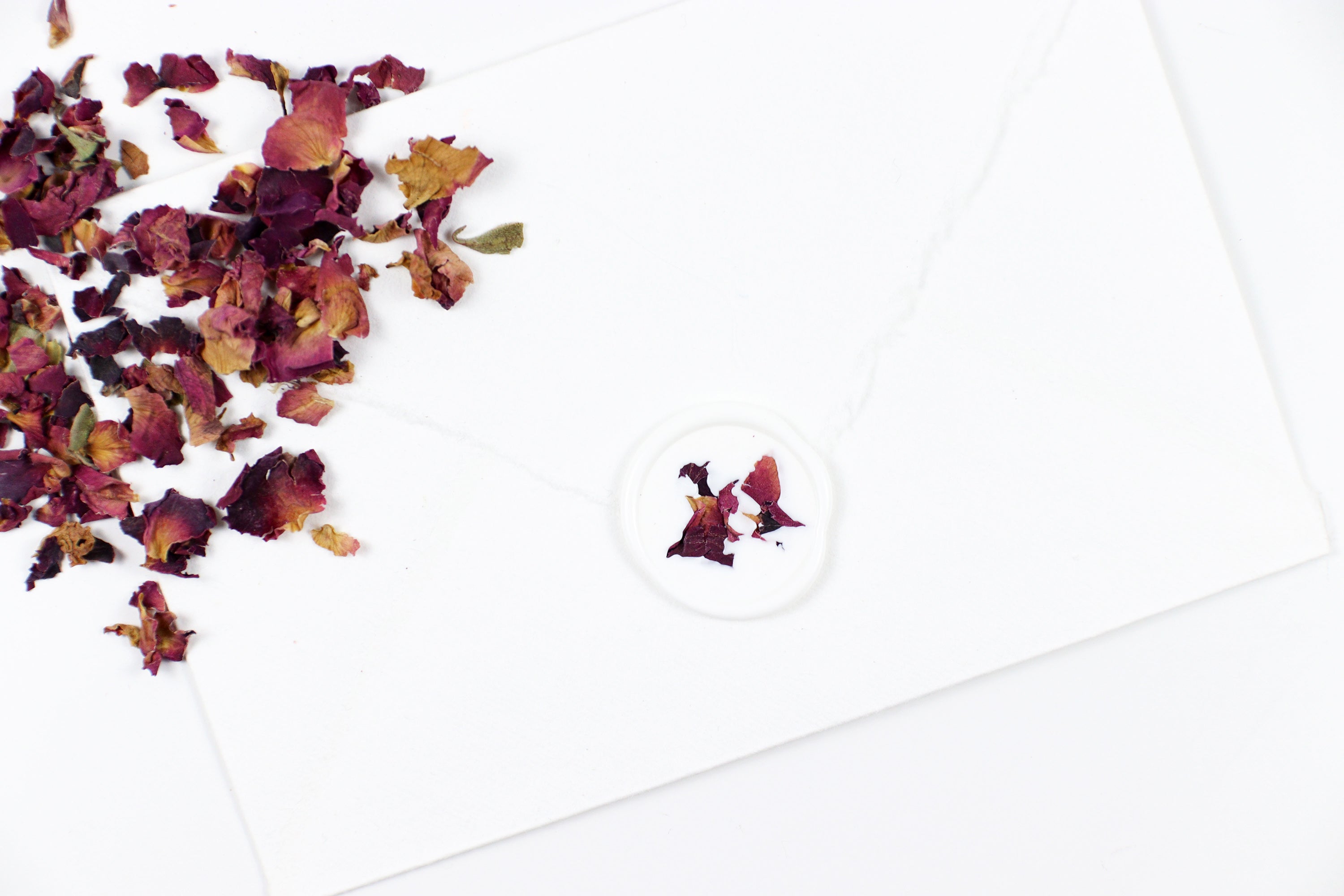 Red Rose Petals on White Wax